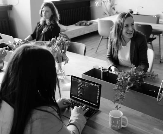 A group of women sitting at an office