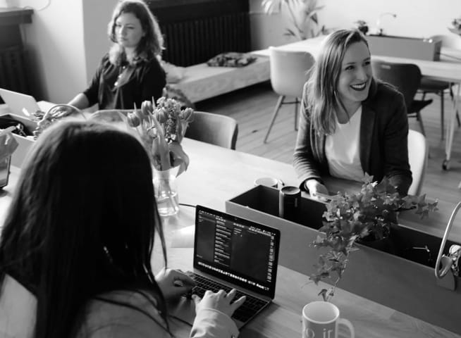 A group of women sitting at an office